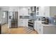 Well-equipped kitchen featuring stainless steel appliances, white cabinets, subway tile backsplash, and hardwood floors at 5286 Wild Indigo Nw Way, Acworth, GA 30102