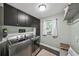 Well-organized laundry room featuring stainless steel appliances, cabinets, and a window for natural light at 5286 Wild Indigo Nw Way, Acworth, GA 30102