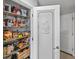 Walk-in pantry with frosted glass door features ample shelving for storage and easy organization at 5286 Wild Indigo Nw Way, Acworth, GA 30102