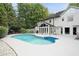 Backyard pool with attached sunroom and adjacent trees provides a calming atmosphere at 5286 Wild Indigo Nw Way, Acworth, GA 30102
