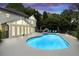 Swimming pool with attached sunroom and outdoor lounge area at 5286 Wild Indigo Nw Way, Acworth, GA 30102