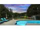 Backyard swimming pool with water feature, lounge chairs, and beautiful lake view at 5286 Wild Indigo Nw Way, Acworth, GA 30102