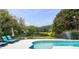 Inviting backyard pool area with lounge chairs, lush greenery, and a serene view of the lake at 5286 Wild Indigo Nw Way, Acworth, GA 30102