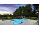 Backyard swimming pool with manicured lawn, mature trees, and view of the lake at 5286 Wild Indigo Nw Way, Acworth, GA 30102