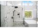 Modern glass shower with marble-like tile and matte black fixtures, complemented by a view to the outdoors at 5286 Wild Indigo Nw Way, Acworth, GA 30102