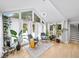 Bright sunroom with large windows, plants, hardwood floors and chairs overlooks the backyard at 5286 Wild Indigo Nw Way, Acworth, GA 30102