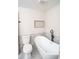 Bathroom featuring a soaking tub, toilet and an accent shelf at 6050 Randy Ln, Ellenwood, GA 30294