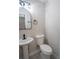 Elegant powder room features pedestal sink, modern lighting, and neutral color palette at 6050 Randy Ln, Ellenwood, GA 30294
