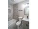 Bathroom featuring gray tile surround, shower with niche, updated vanity, and modern fixtures at 6050 Randy Ln, Ellenwood, GA 30294