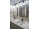 Modern bathroom with double vanity, quartz countertop, black hardware, and shower with tile surround at 6050 Randy Ln, Ellenwood, GA 30294