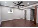 Bedroom with a ceiling fan and dark wood floors at 6050 Randy Ln, Ellenwood, GA 30294