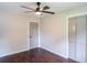 Bedroom featuring neutral walls, modern ceiling fan, wood-look floors, and closet at 6050 Randy Ln, Ellenwood, GA 30294