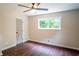 Bedroom with wood-look flooring, natural light, and neutral paint at 6050 Randy Ln, Ellenwood, GA 30294