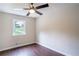 Cozy bedroom with hardwood floors, ceiling fan, and natural light at 6050 Randy Ln, Ellenwood, GA 30294