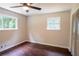 Bedroom features wood-look floors, two windows, ceiling fan, and closet at 6050 Randy Ln, Ellenwood, GA 30294
