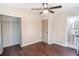 Bedroom features wood-look floors, ceiling fan, and ensuite bathroom at 6050 Randy Ln, Ellenwood, GA 30294