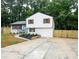 Charming two-story home featuring a bright blue front door, fresh landscaping, and a newly paved driveway at 6050 Randy Ln, Ellenwood, GA 30294
