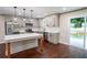 Bright, open-concept kitchen featuring stainless steel appliances, an island with seating, and plenty of counter space at 6050 Randy Ln, Ellenwood, GA 30294