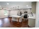 Bright, open-concept kitchen featuring stainless steel appliances, an island with seating, and plenty of counter space at 6050 Randy Ln, Ellenwood, GA 30294