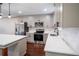 Modern kitchen showcasing gray cabinets, stainless steel appliances and white stone countertops at 6050 Randy Ln, Ellenwood, GA 30294