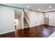 Spacious living room showcasing beautiful wood floors, neutral paint and stairs to the lower level at 6050 Randy Ln, Ellenwood, GA 30294