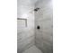 Walk-in shower showcases tile surround, a shower niche, and sleek black hardware at 6050 Randy Ln, Ellenwood, GA 30294