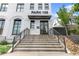 Entrance to the building featuring concrete steps with black metal handrails leading to a glass door at 108 Park Pl # 110, Decatur, GA 30030