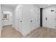 Hallway with hardwood floors, access to bathroom, and in-unit laundry at 108 Park Pl # 110, Decatur, GA 30030