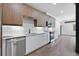 Modern kitchen with wood cabinets, stainless steel appliances, white countertops, and subway tile backsplash at 108 Park Pl # 110, Decatur, GA 30030