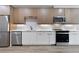 Modern kitchen with stainless steel appliances, wood cabinets, white countertops, and a subway tile backsplash at 108 Park Pl # 110, Decatur, GA 30030