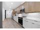 Modern kitchen with stainless steel appliances, wooden cabinets, white countertops, and subway tile backsplash at 108 Park Pl # 110, Decatur, GA 30030