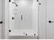 Contemporary shower features white tile, glass doors, and black hardware at 108 Park Pl # 110, Decatur, GA 30030