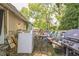 Rear wooden porch cluttered with various items, table and chairs, grill at 1454 Beecher Sw St, Atlanta, GA 30310