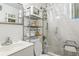 Small bathroom with shower/tub combo, storage and basic sink at 1454 Beecher Sw St, Atlanta, GA 30310