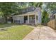 Charming two-story home featuring a screened-in front porch and mature trees at 1454 Beecher Sw St, Atlanta, GA 30310