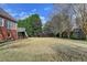 Large, grassy backyard with mature trees, perfect for outdoor activities and relaxation at 2324 Blackberry Ct, Snellville, GA 30078