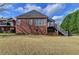Expansive backyard featuring a well-manicured lawn and views of the home's exterior at 2324 Blackberry Ct, Snellville, GA 30078