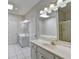 Bright bathroom featuring white tile floors, double vanity and soaking tub providing a spa-like feel at 2324 Blackberry Ct, Snellville, GA 30078