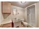 Basement bathroom includes a shower, toilet, vanity, sink and practical storage at 2324 Blackberry Ct, Snellville, GA 30078