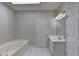 This is a bright bathroom with a soaking tub, vanity, and skylight, for a spa-like experience at 2324 Blackberry Ct, Snellville, GA 30078