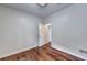 Bedroom featuring hardwood floors, natural light, and an adjacent room beyond the open door at 2324 Blackberry Ct, Snellville, GA 30078