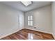 Bedroom with hardwood floors, natural light from window with shutters, and a classic paneled door at 2324 Blackberry Ct, Snellville, GA 30078