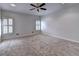 Spacious bedroom featuring neutral carpet, white walls, and two windows with plantation shutters at 2324 Blackberry Ct, Snellville, GA 30078