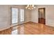 Elegant dining room filled with natural light has beautiful hardwood flooring and a decorative chandelier at 2324 Blackberry Ct, Snellville, GA 30078