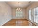 Bright dining area with hardwood flooring, chair rail, and a decorative chandelier at 2324 Blackberry Ct, Snellville, GA 30078