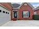 Close-up of the home's entrance, showcasing the brick facade, garage, and well-maintained landscaping at 2324 Blackberry Ct, Snellville, GA 30078