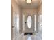 Bright foyer with white tile floor, decorative front door, and neutral wall color at 2324 Blackberry Ct, Snellville, GA 30078