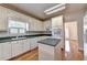 Classic white kitchen features updated appliances, wood floors, and plenty of natural light at 2324 Blackberry Ct, Snellville, GA 30078