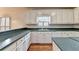 Bright kitchen with white cabinets, countertops, and hardwood floors offers ample storage and work space at 2324 Blackberry Ct, Snellville, GA 30078