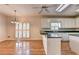 Open eat-in kitchen with natural wood flooring, white cabinets, and plenty of natural light at 2324 Blackberry Ct, Snellville, GA 30078